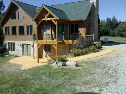 Timber-frame home with a deck and stone accents